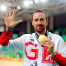 Bradley Wiggins celebrates with his gold medal following victory in the men's team pursuit final