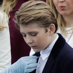 President-elect Donald Trump's wife Melania Trump adjusts Barron Trump's tie before the 58th Presidential Inauguration for President-elect Donald Trump at the U.S. Capitol in Washington, Friday, Jan. 20, 2017. (AP Photo/Patrick Semansky)