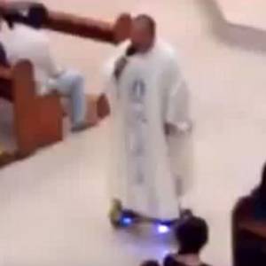 Father Albert San Jose on his hoverboard at mass