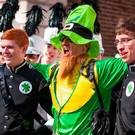 Going green: a man dressed as a leprechaun with Coppell High School Marching Band