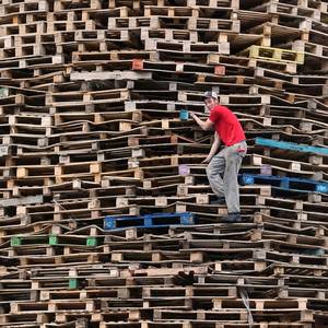 A bonfire builder at work in the New Mosley area of Belfast. Niall Carson/PA Wire.