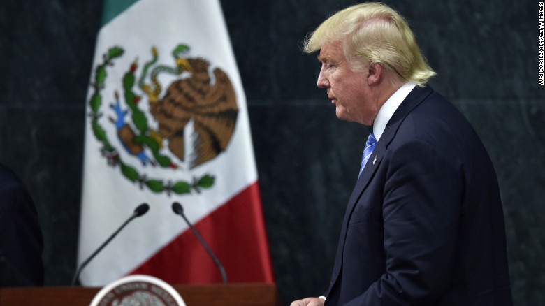 US presidential candidate Donald Trump leaves after a joint press conference with Mexican President Enrique Pena Nieto (out of frame) in Mexico City on August 31, 2016.
Donald Trump was expected in Mexico Wednesday to meet its president, in a move aimed at showing that despite the Republican White House hopeful's hardline opposition to illegal immigration he is no close-minded xenophobe. Trump stunned the political establishment when he announced late Tuesday that he was making the surprise trip south of the border to meet with President Enrique Pena Nieto, a sharp Trump critic.
 / AFP / YURI CORTEZ        (Photo credit should read YURI CORTEZ/AFP/Getty Images)