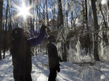 In this Sunday, Jan. 15, 2017 photo, USDA Forest Service researchers Paul Schaberg, left, and Lindsey Rustad, right, examine the aftermath of a manufactured ice storm at the Hubbard Brook Experimental Forest in Woodstock, N.H. A team of scientists sprayed water on the trees the night before as part of a study designed to examine the effects of ice on northern forests. (AP Photo/Holly Ramer)