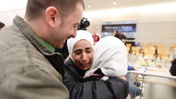 Hisham, left, and Mariam Yasin, centre, welcome their mother Najah al-Shamieh, from Syria, after immigration authorities ...