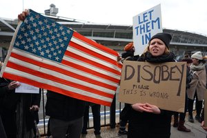 Protesters assemble at John F. Kennedy International Airport in New York, Saturday, Jan. 28, 2017 after two Iraqi refugees were detained while trying to enter the country.