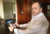 Michael Paino looks at daughter's image on Ipad