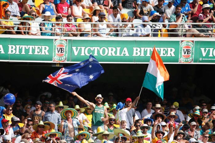 Cricket fans wave an Australian and Indian flag at the Gabba