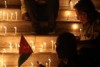 Jordanians in Amman hold candles at a vigil for six Jordanian soldiers killed in a suicide bombing on their border with Syria