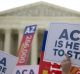 A demonstrator in support of US President Barack Obama's healthcare law, the Affordable Care Act after the US Supreme ...