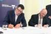 Victorian Premier Daniel Andrews and a Fujitsu representative sign paperwork