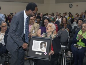 File - NASA Langley Deputy Center Director Clayton Turner presents Katherine G. Johnson with a framed version of a plaque describing her contributions to the agency and the nation. On Thursday, May 5, 2016, a ceremony was held naming the center's Computational Research Facility after Johnson.