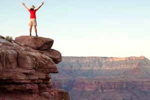 A woman standing on the rim of the Grand Canyon.