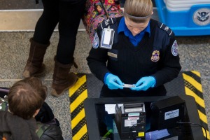 Transportation Security Administration (TSA) officers check passenger's identification at a security checkpoint at ...