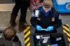 Transportation Security Administration (TSA) officers check passenger's identification at a security checkpoint at ...
