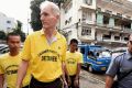 Peter Scully (2nd from left) arrives at the Cagayan De Oro court handcuffed to another inmate on his first day of his ...