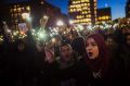 At Washington Square Park in New York, Muslim women shout slogans during a rally against President Donald Trump's order ...