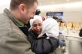 Hisham, left, and Mariam Yasin, centre, welcome their mother Najah al-Shamieh, from Syria, after immigration authorities ...