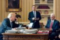 President Donald Trump, accompanied by Chief of Staff Reince Priebus and Vice-President Mike Pence, speaks on the phone ...