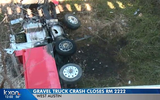 Wreck: The truck caught fire and crashed down a ravine, however the driver miraculously survived  