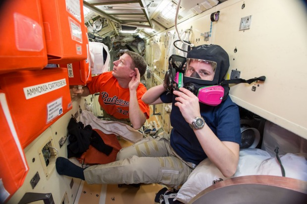 Terry Virts, left, assists European Space Agency astronaut Samantha Cristoforetti with emergency training aboard the ...