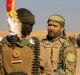 Fighters of the Popular Mobilisation Forces stand at the front line outside Mosul in November.