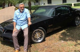 Burt Reynolds with his 1978 Pontiac Firebird Trans Am.