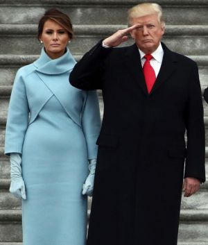 President Donald Trump with first lady Melania Trump and Major General Bradley Becker review troops in Washington.