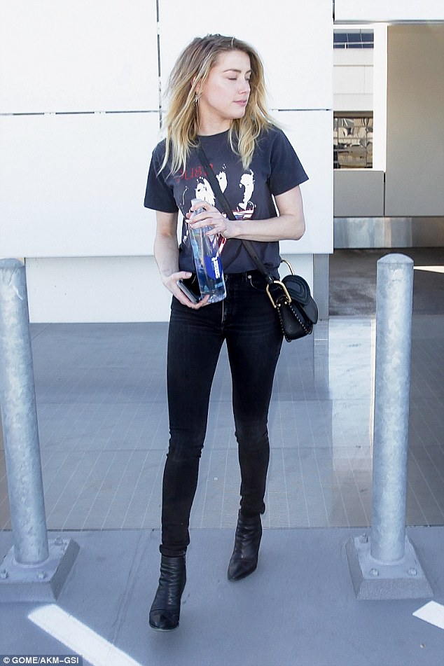 Rock chick chic: The actress, 30, looked the epitome of rocker chic as she sported a Van Halen T-shirt and skintight jeans, sporting a huge grin as she headed to a waiting car 