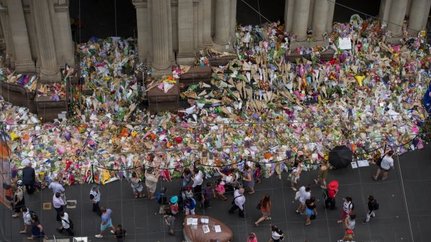 Crowds gather at the floral tribute memorial commemorating the lives of the victims of the Bourke Street attack.