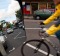 In view: a cyclist passes a parked car.