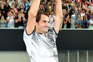 MELBOURNE, AUSTRALIA - JANUARY 29: Roger Federer of Switzerland celebrates with fans in Margaret Court Arena as he holds ...