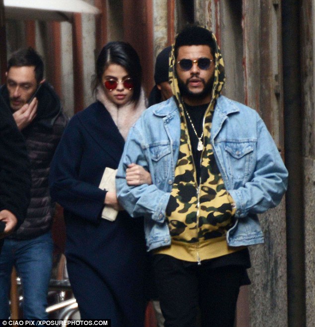 She can't let go! Selena Gomez held onto The Weeknd's arm as they toured Venice, Italy on Monday afternoon