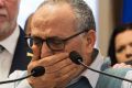 Mohamed Labibi, president of the Islamic cultural center, is comforted by Quebec Premier Philippe Couillard, left, and ...