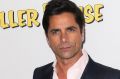 A hairstyle in search of a personality: John Stamos returns for Netflix's Fuller House.