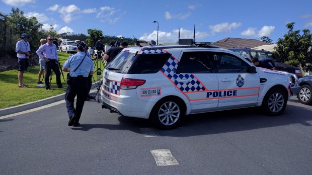 Police and media gather at a home in Pimpama, on the Gold Coast, where two bodies were found.