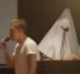 Two men dressed in white hoods and white linen interrupted the Young Liberal council meeting in Sydney.