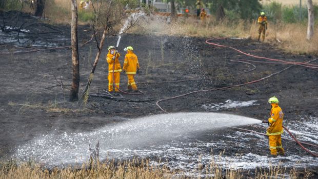 Emergency services mopping up after Umbagong District Park grass fire in Latham which came within 50 metres of homes.