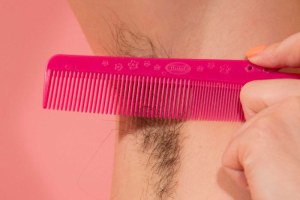 A woman's armpit with her hair grown out, and a comb (Supplied: Ashley Armitage)