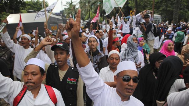 Indonesian Muslims  demonstrate outside the court where Jakarta Governor Basuki Tjahaja Purnama, also known as Ahok, is ...