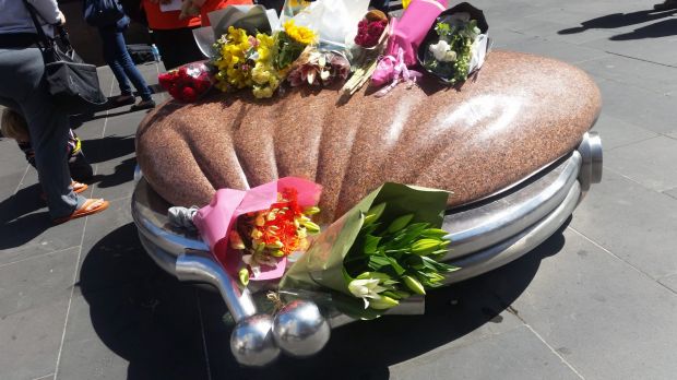 Flowers on the purse artwork, near where buskers often play in the mall.