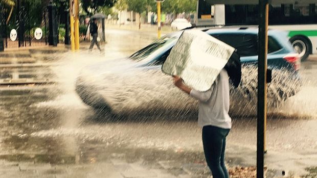 A sunshade had to be re-appropriated to a rain cover after unusual summer deluge hit Perth.