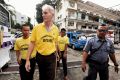Peter Scully (second from left) arrives at the Cagayan De Oro court handcuffed to another inmate on the first day of his ...