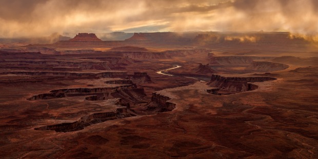 This is shot is taken at Canyonlands National Park in Utah, USA. A storm brought in hanging cloud and eeire light at ...