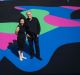 Architect and arts patron Corbett Lyon with his wife Yueji standing on Reko Rennie's <i>Visible Invisible</i>, painted ...