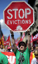 Protestor's placard reads: 'Stop evictions'. Locksmiths and firefighters have refused to cooperate with evictions in Spain