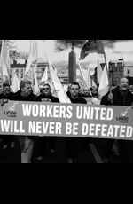 Workers carry a banner with the slogan Workers united will never be defeated