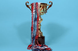 trophy with red, white, and blue streamers