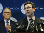 Washington Attorney General Bob Ferguson, right, talks to reporters as Gov. Jay Inslee, left, looks on, Monday, Jan. 30, 2017, in Seattle. Ferguson announced that he is suing President Donald Trump over an executive order that suspended immigration from seven countries with majority-Muslim populations and sparked nationwide protests. (AP Photo/Ted S. Warren)