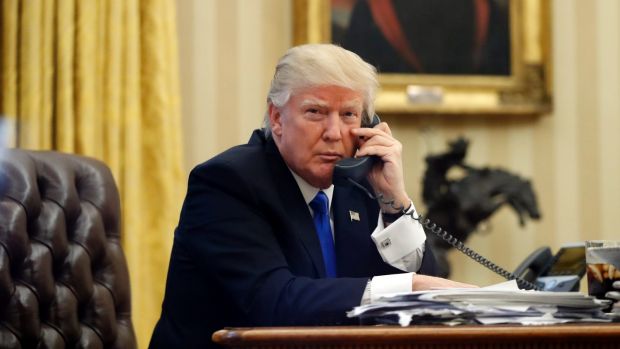 President Donald Trump speaks on the phone with Prime Minister of Australia Malcolm Turnbull in the Oval Office of the ...