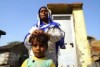 Mehram Habeeb and son in front of toilet in an Indian village where people are fined for outside defecation.